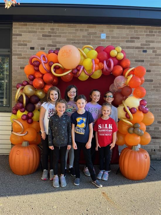 Students in front of fall balloon arch